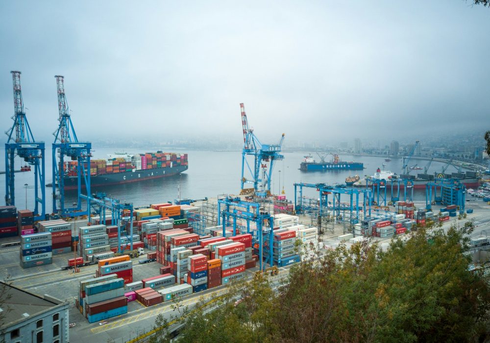 Photo by David Vives blue and red cargo ship on sea during daytime
